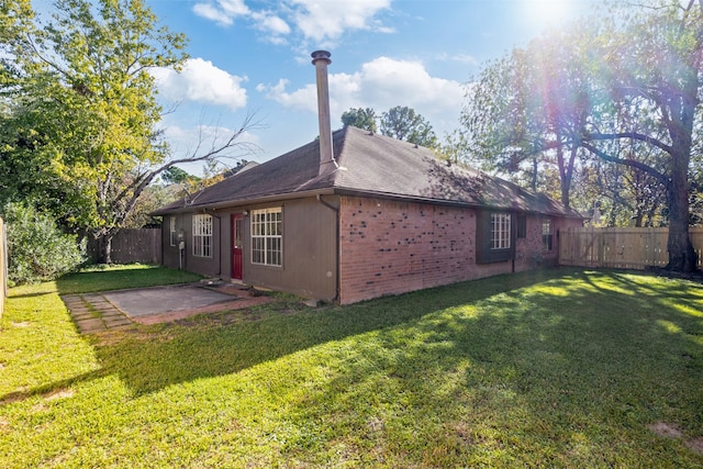 view of home's exterior with a yard and a patio