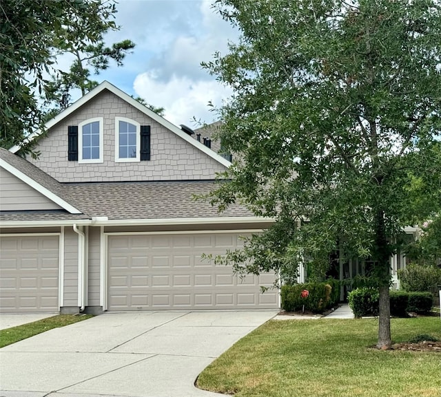 view of front of house featuring a garage and a front yard