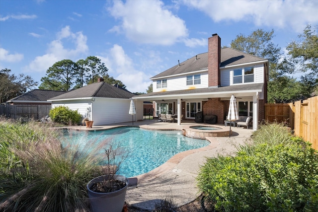 view of pool featuring a patio area and an in ground hot tub