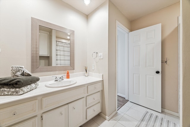 bathroom featuring tile patterned flooring, a shower with curtain, and vanity