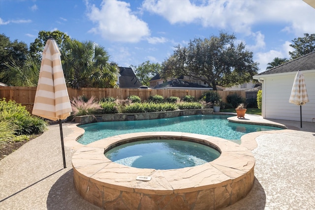 view of swimming pool featuring an in ground hot tub and a patio