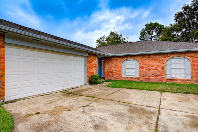 ranch-style house featuring a garage