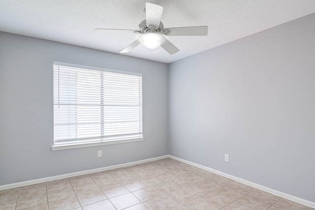 unfurnished room featuring light tile patterned floors, a textured ceiling, and ceiling fan