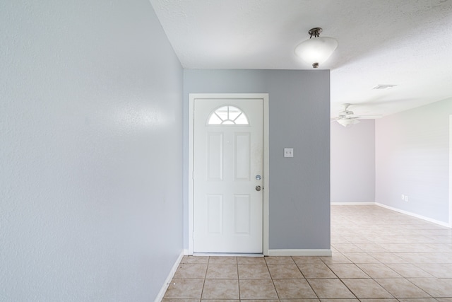 tiled entrance foyer featuring ceiling fan