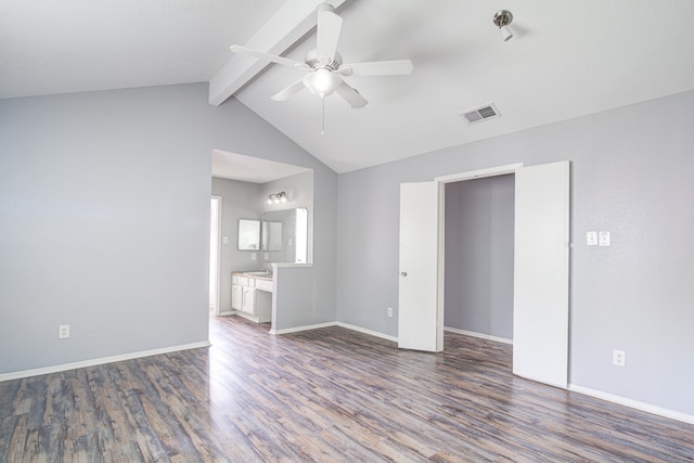 spare room with lofted ceiling with beams, ceiling fan, and dark wood-type flooring