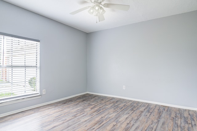 unfurnished room with ceiling fan and hardwood / wood-style flooring