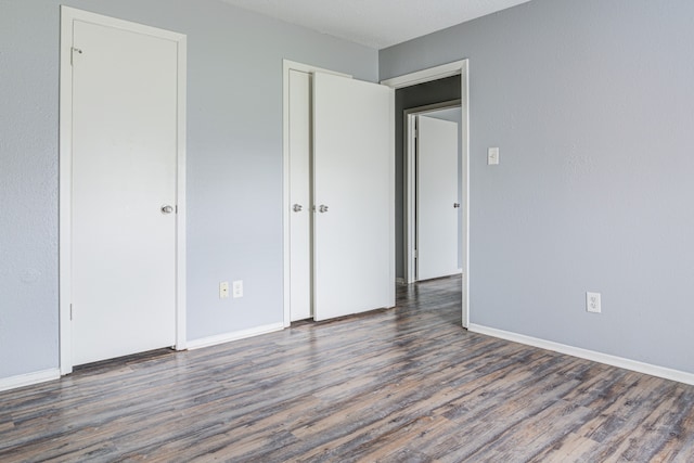 unfurnished bedroom featuring dark hardwood / wood-style flooring