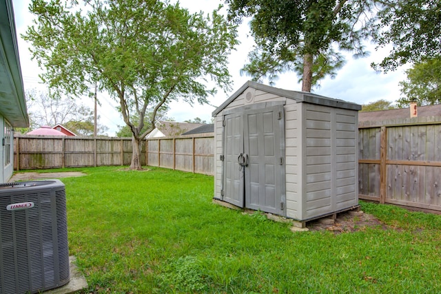 view of outdoor structure featuring a lawn and cooling unit