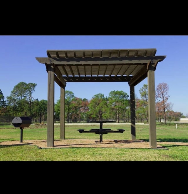 surrounding community with a pergola and a yard