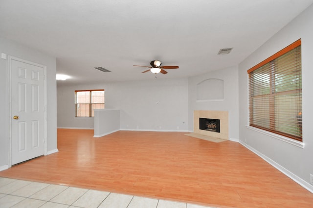 unfurnished living room with ceiling fan and light hardwood / wood-style flooring