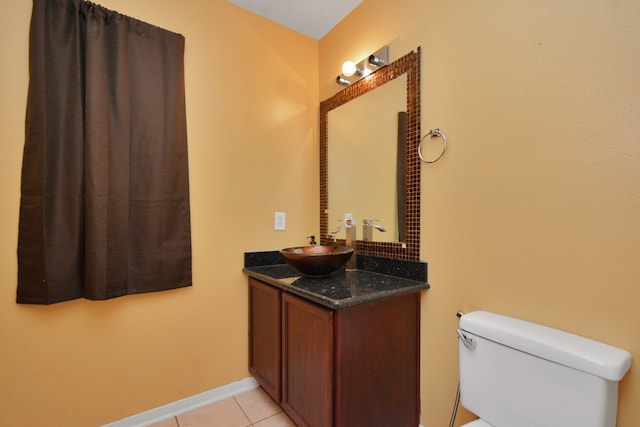 bathroom featuring tile patterned flooring, vanity, and toilet