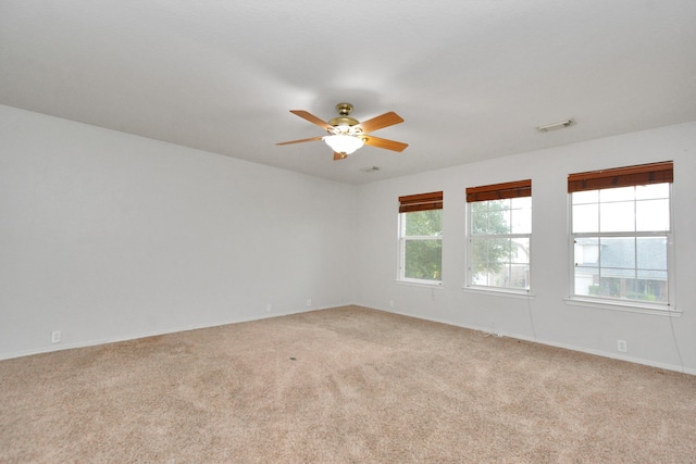 empty room featuring light colored carpet and ceiling fan