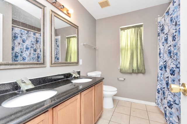 bathroom featuring tile patterned floors, vanity, toilet, and walk in shower