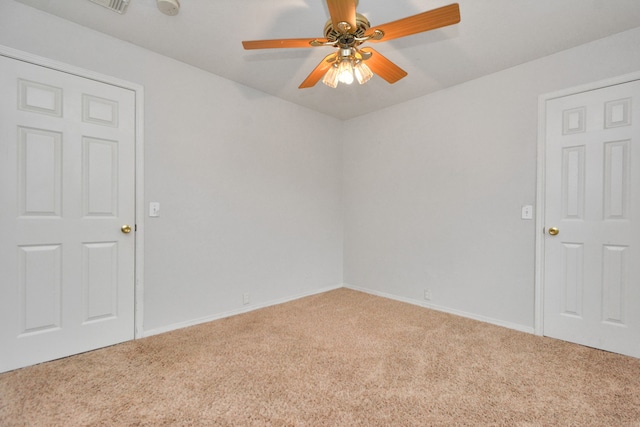 spare room featuring carpet floors and ceiling fan