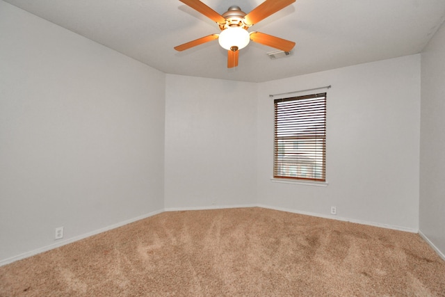 carpeted spare room with ceiling fan