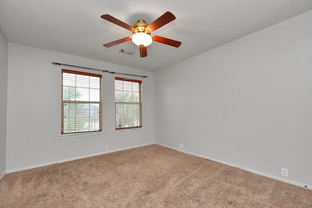 unfurnished room featuring light carpet and ceiling fan