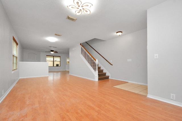 unfurnished living room with light hardwood / wood-style floors and ceiling fan