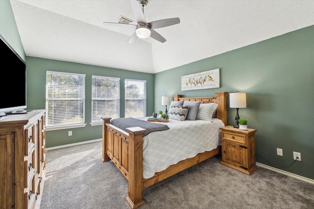 carpeted bedroom with vaulted ceiling, a textured ceiling, a ceiling fan, and baseboards