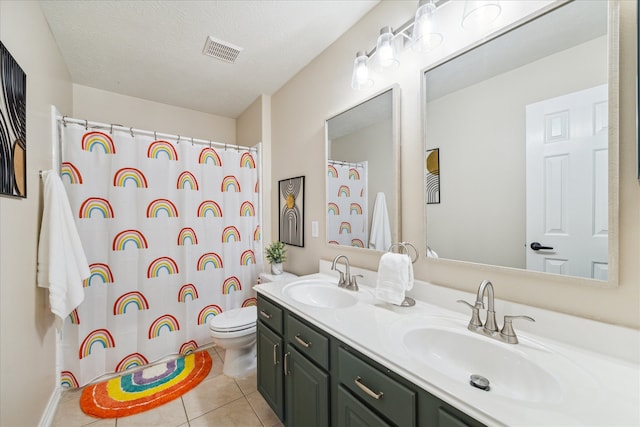 bathroom featuring toilet, a sink, visible vents, and tile patterned floors