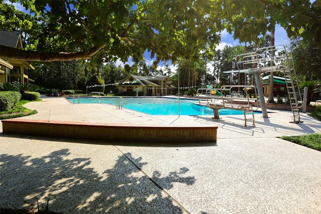 pool featuring a patio and fence