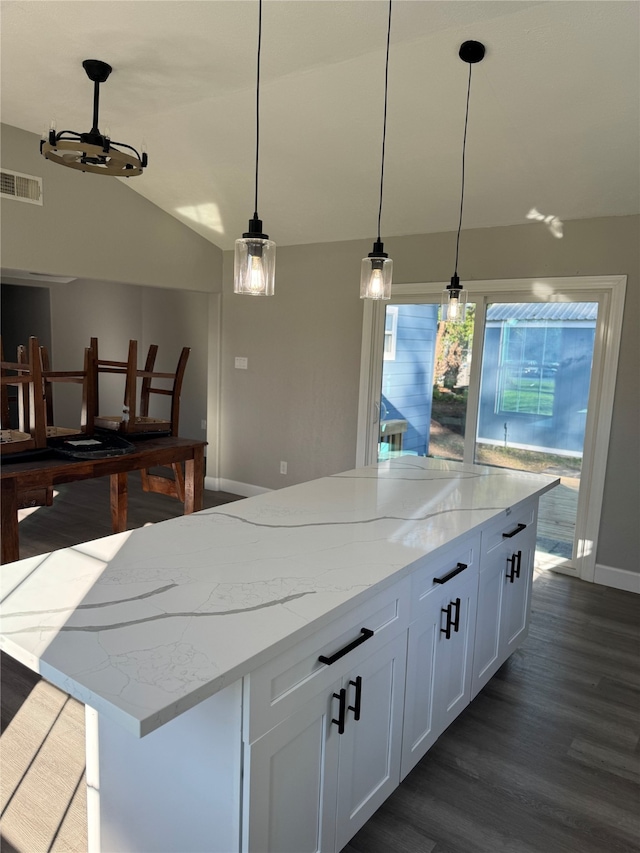 kitchen with white cabinets, pendant lighting, lofted ceiling, and dark wood-type flooring