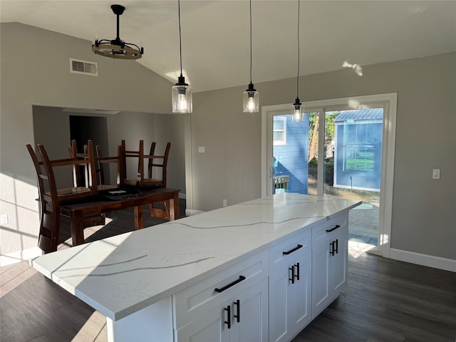 kitchen with lofted ceiling, dark hardwood / wood-style floors, white cabinetry, and hanging light fixtures