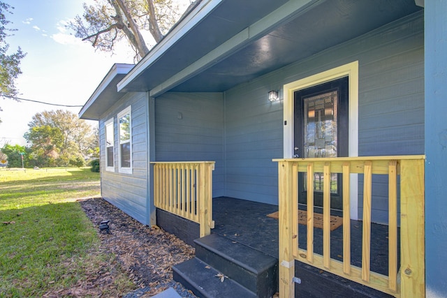 view of exterior entry featuring a yard