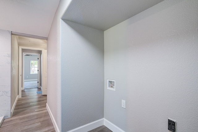 laundry area with wood-type flooring and hookup for a washing machine