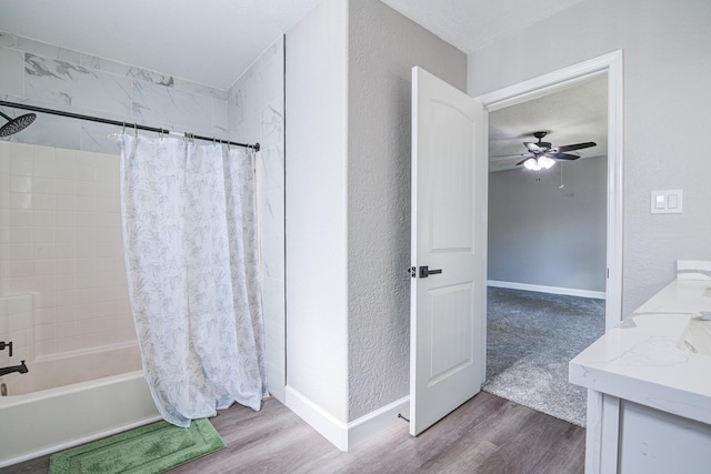 bathroom featuring ceiling fan, vanity, shower / bath combo, and hardwood / wood-style floors