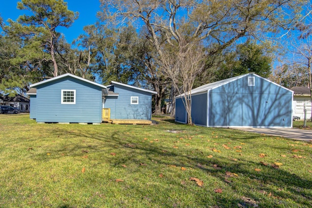 back of property featuring a yard and an outdoor structure