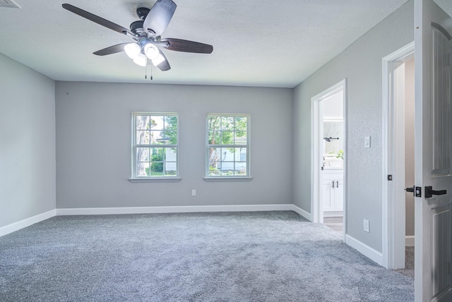 carpeted empty room featuring ceiling fan