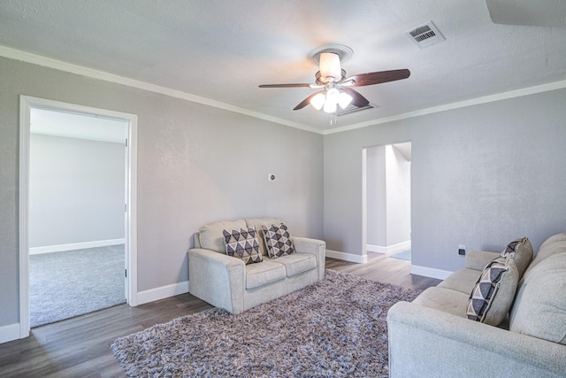 living room featuring hardwood / wood-style flooring, ornamental molding, and ceiling fan