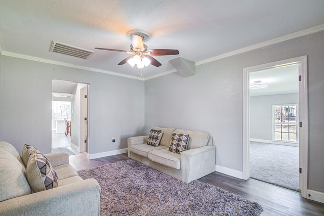 living room with ceiling fan, hardwood / wood-style floors, crown molding, and a textured ceiling