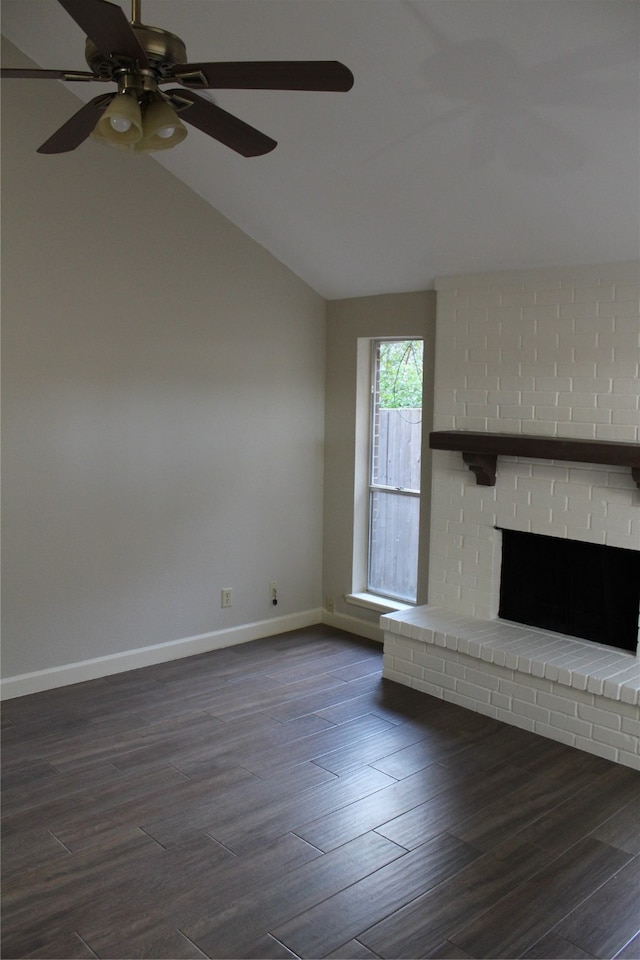 unfurnished living room with ceiling fan, dark hardwood / wood-style flooring, lofted ceiling, and a brick fireplace