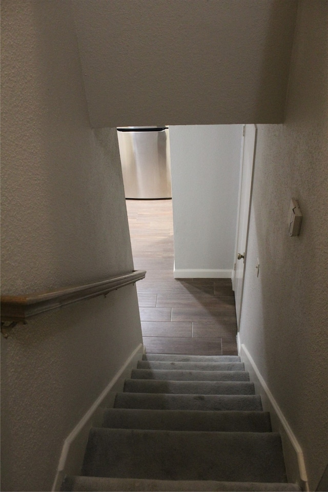 stairs with hardwood / wood-style flooring