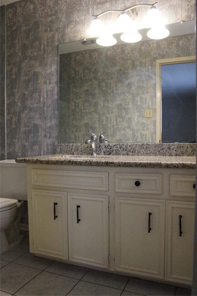 bathroom featuring tile patterned floors, vanity, and toilet