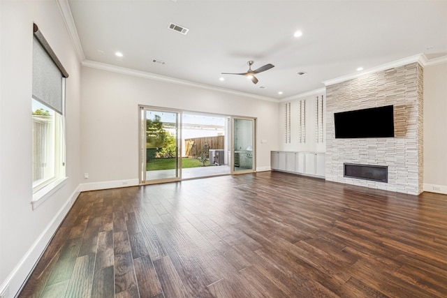 unfurnished living room with dark hardwood / wood-style floors, ceiling fan, ornamental molding, and a fireplace