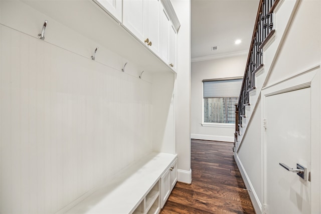 mudroom with dark hardwood / wood-style floors and crown molding