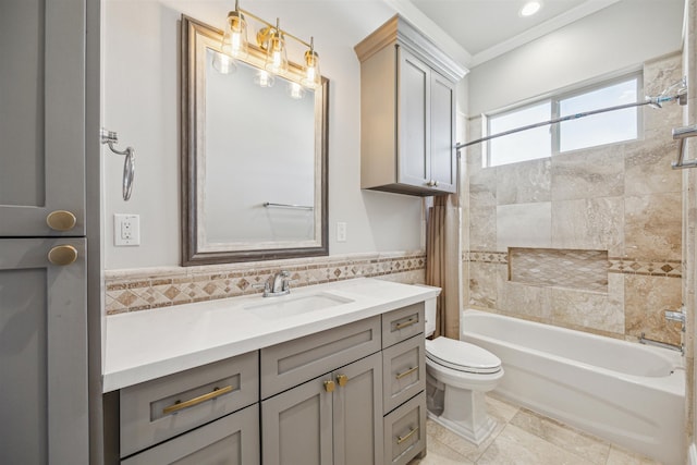 full bathroom featuring vanity, crown molding, toilet, shower / bathtub combination with curtain, and tile walls