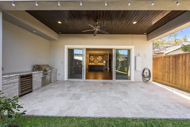 view of patio featuring ceiling fan, grilling area, and wine cooler