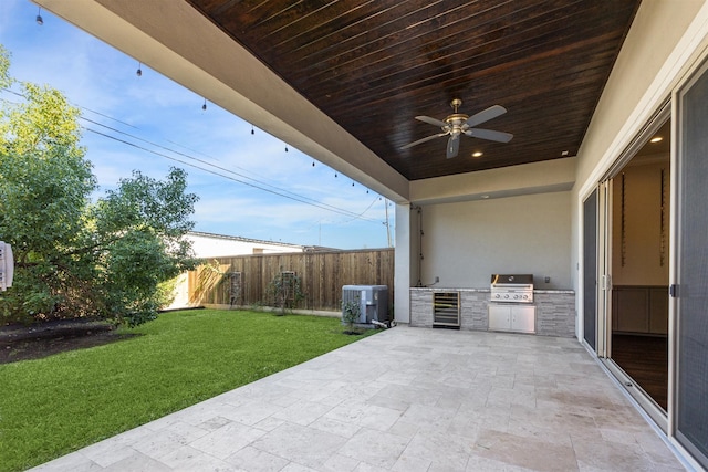 view of patio / terrace featuring area for grilling, ceiling fan, exterior kitchen, central AC unit, and wine cooler