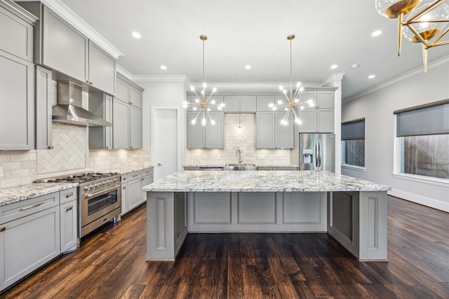 kitchen with dark hardwood / wood-style flooring, a center island, stainless steel appliances, and hanging light fixtures