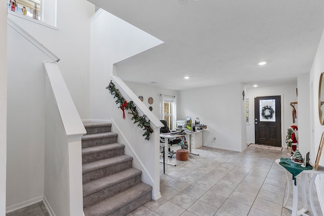 foyer entrance featuring light tile patterned flooring