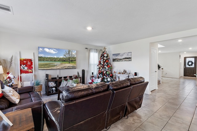 tiled living room with a textured ceiling