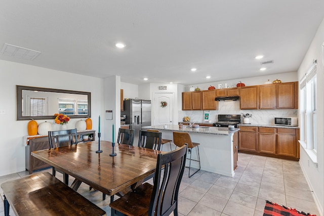 dining space featuring light tile patterned floors