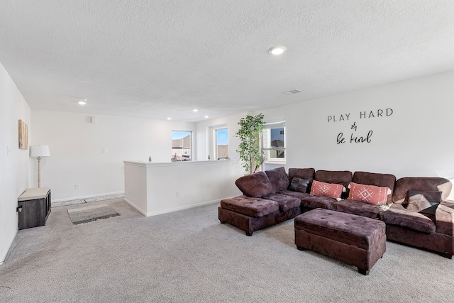 carpeted living room featuring a textured ceiling