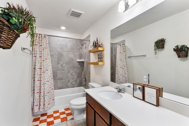 full bathroom featuring shower / tub combo, tile patterned floors, vanity, a textured ceiling, and toilet