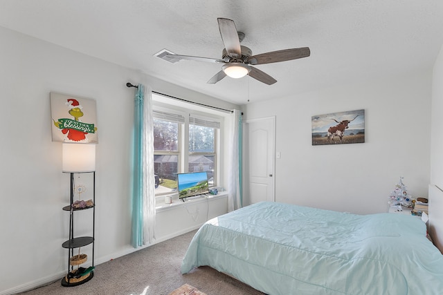 bedroom with carpet, a textured ceiling, and ceiling fan