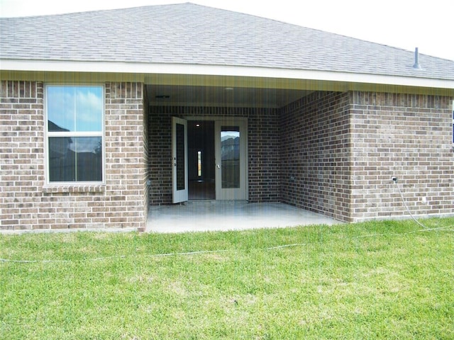 back of house featuring a patio area and a yard