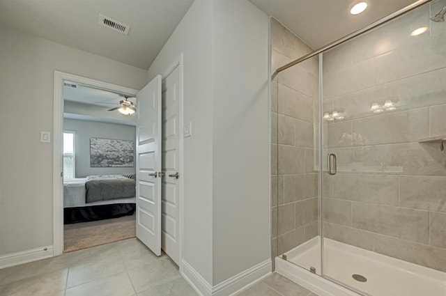 bathroom with tile patterned floors, ceiling fan, and a shower with shower door